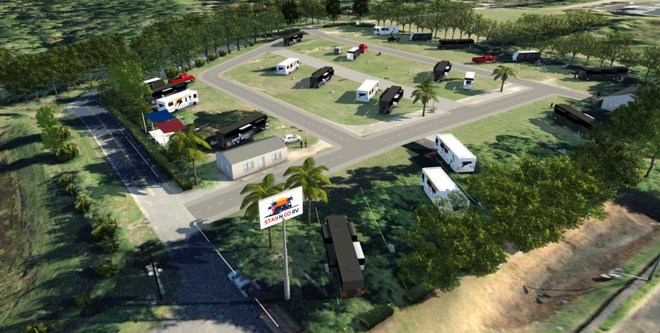 Aerial view of a RV campground with vehicles parked on grassy lots, trees, and a sign.