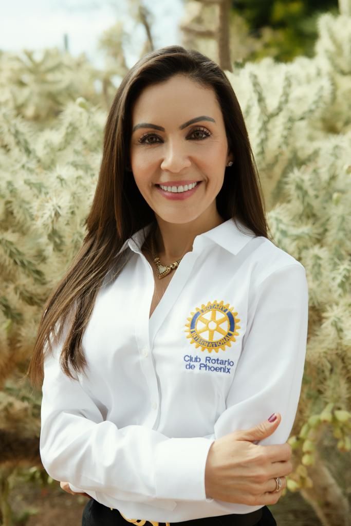 A Woman Is Wearing A White Shirt With A Rotary Logo On It - Phoenix, AZ - Pescaderia El Puerto De Guaymas