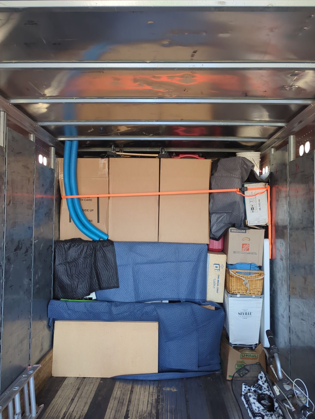 The Inside of a Moving Truck Filled With Boxes and a Couch