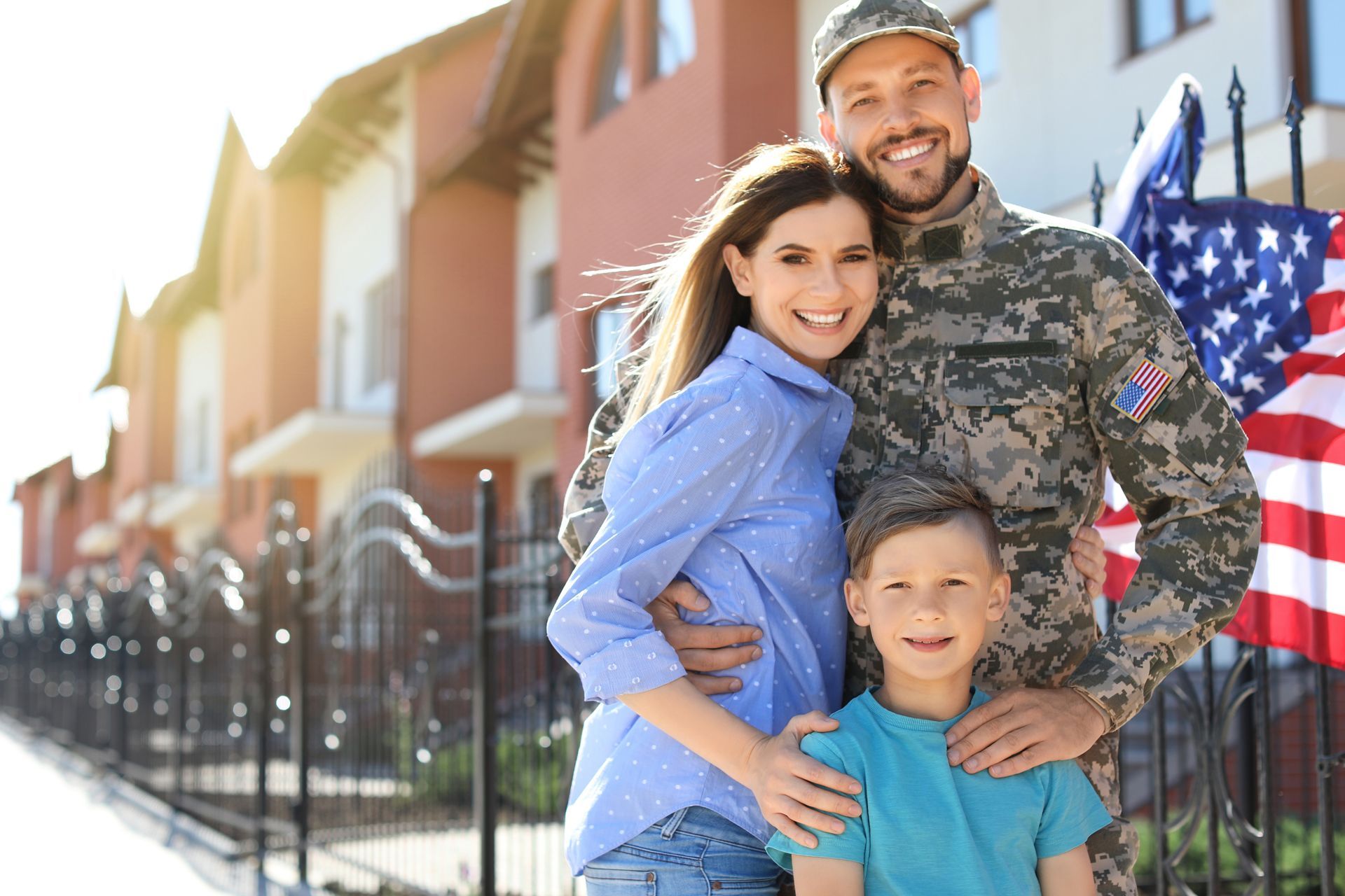 A Soldier and His Family Are Posing for a Picture in Front of a House