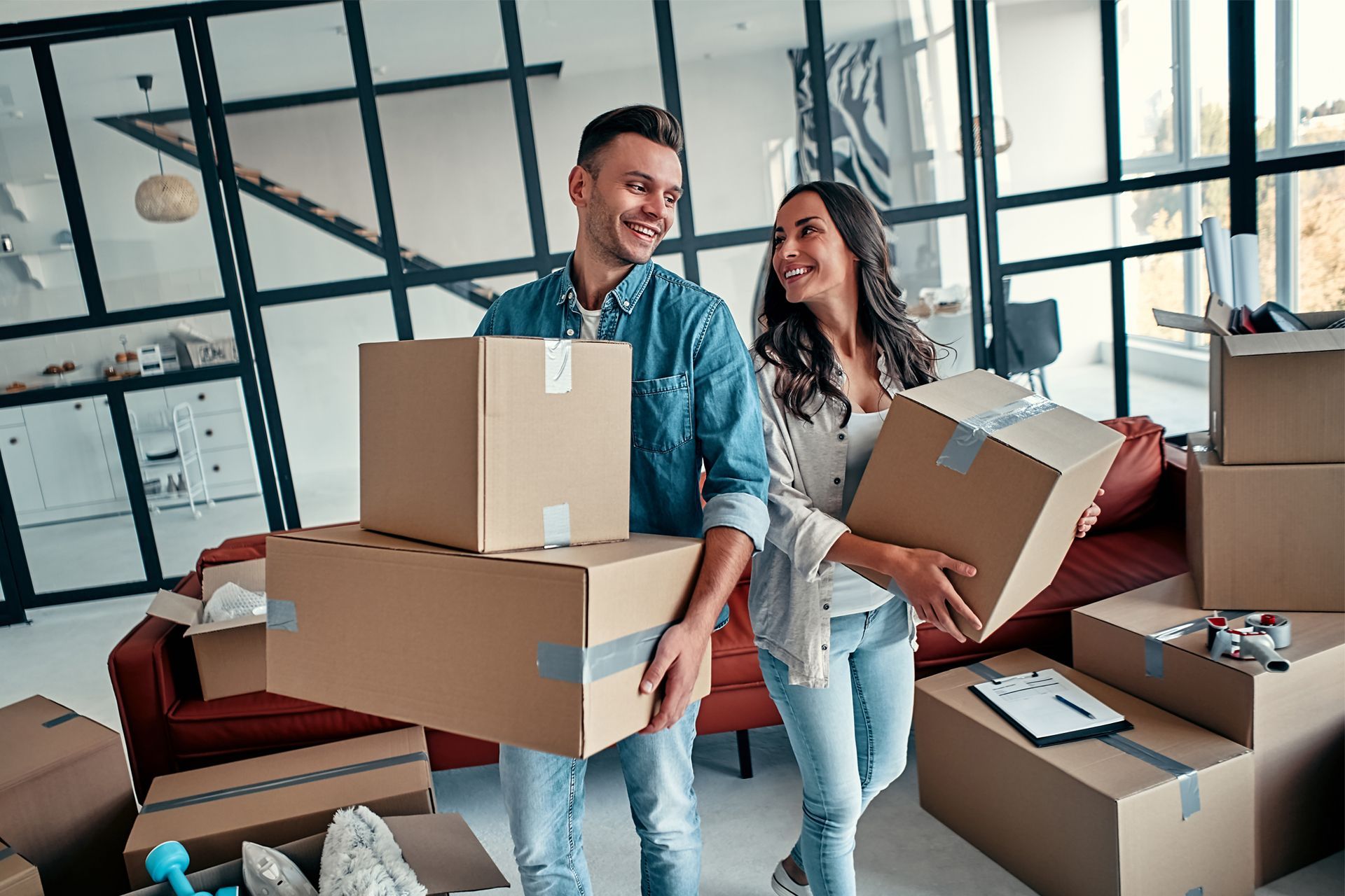 Happy Couple Holding Moving Boxes