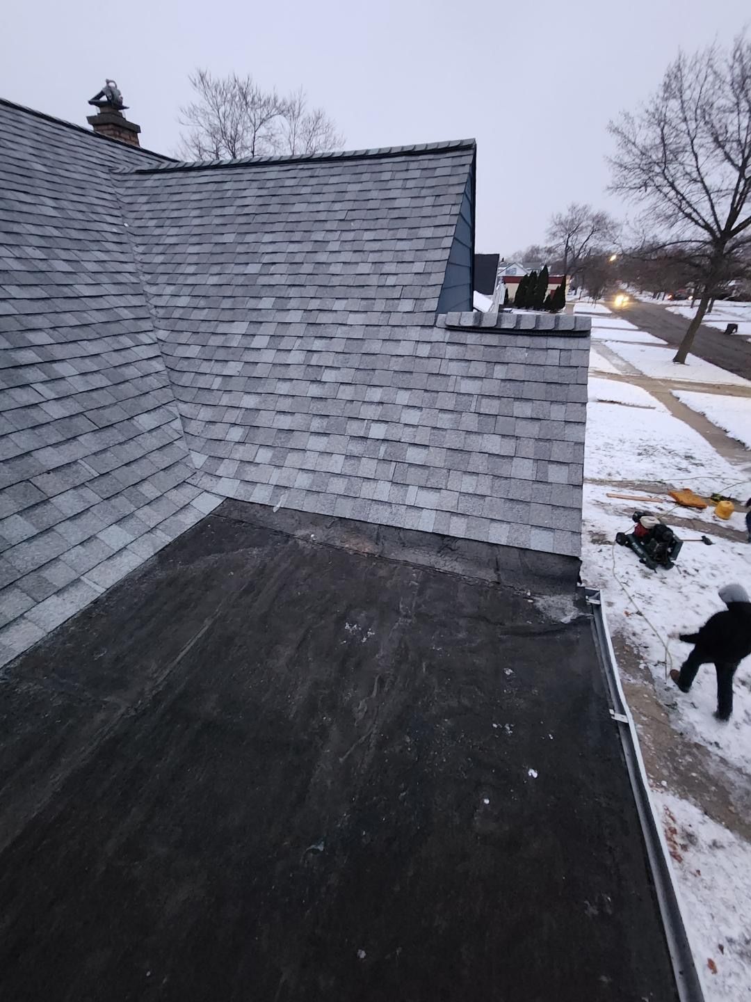 Close-up of a gray metal roof with curved, wave-like ridges, possibly for a building's structure.