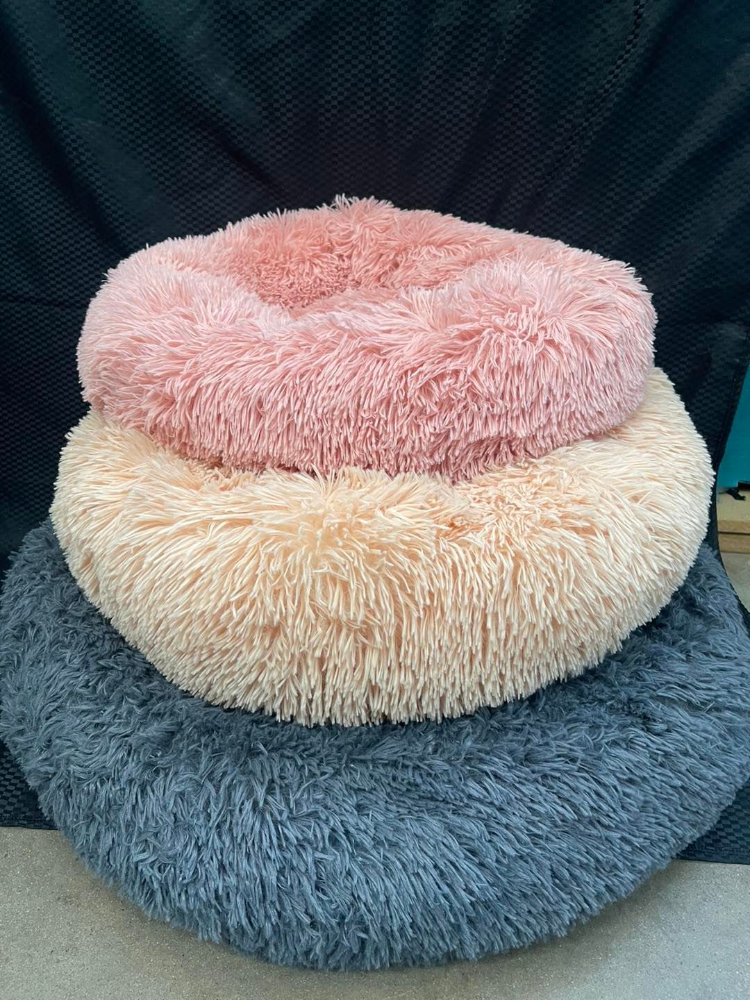 A Pile of Fluffy Pillows Stacked on Top of Each Other — Perfect Pets Kingaroy Professional Dog Grooming in Kingaroy, QLD