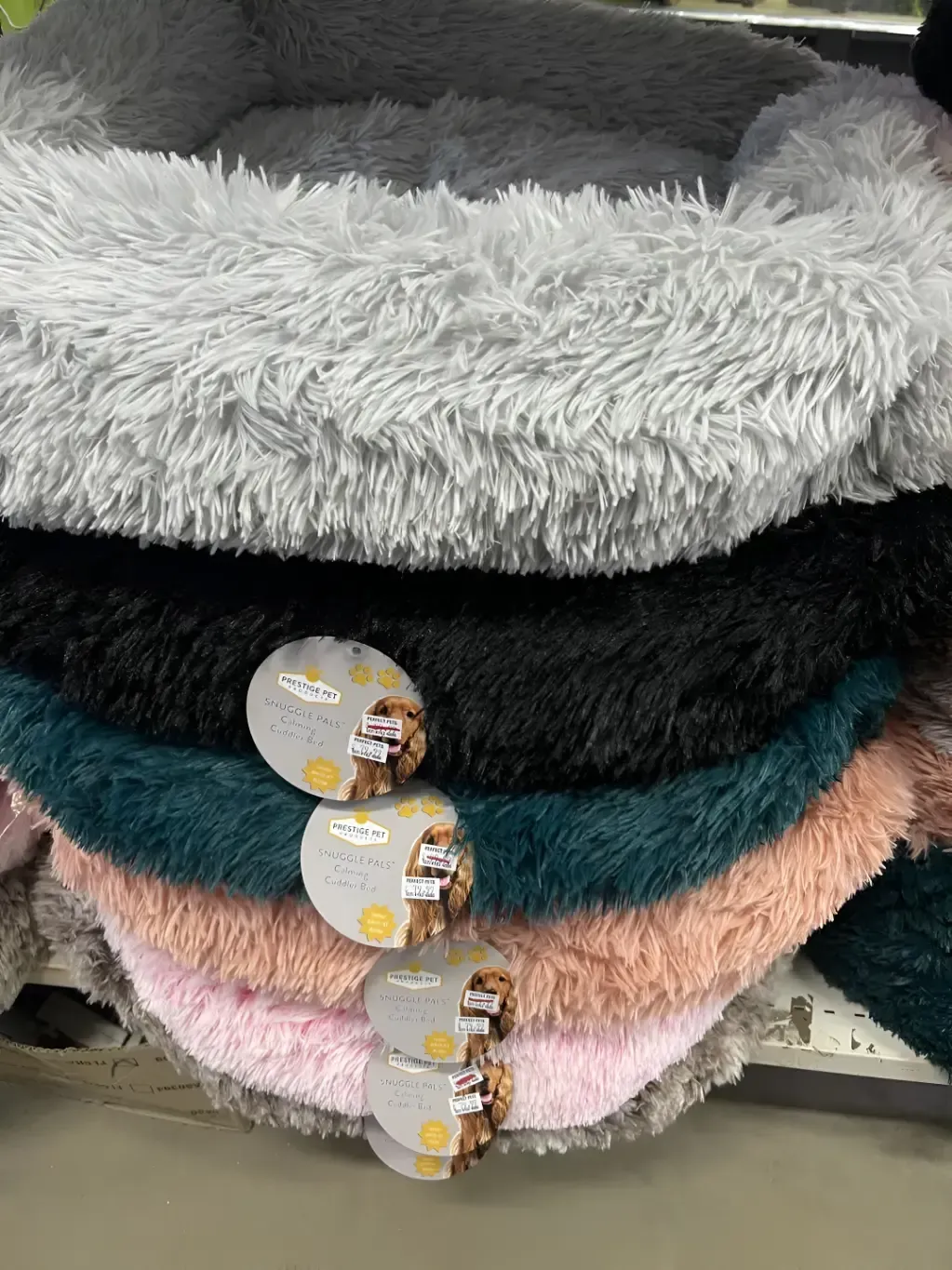 A Pile of Fluffy Dog Beds in Different Colors Are Stacked — Perfect Pets Kingaroy Professional Dog Grooming in Kingaroy, QLD