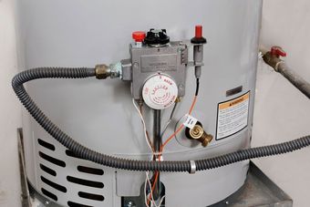 Gas water heater, with controls including a thermostat, safety valve, and gas line.