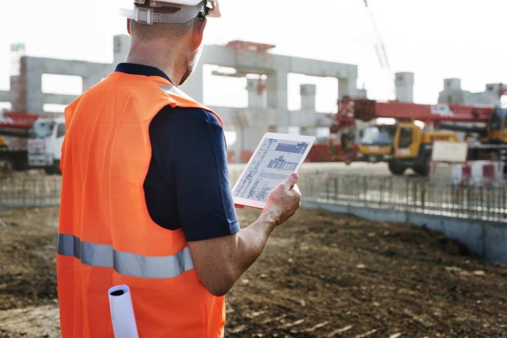 Construction Worker Holding A House Blueprint