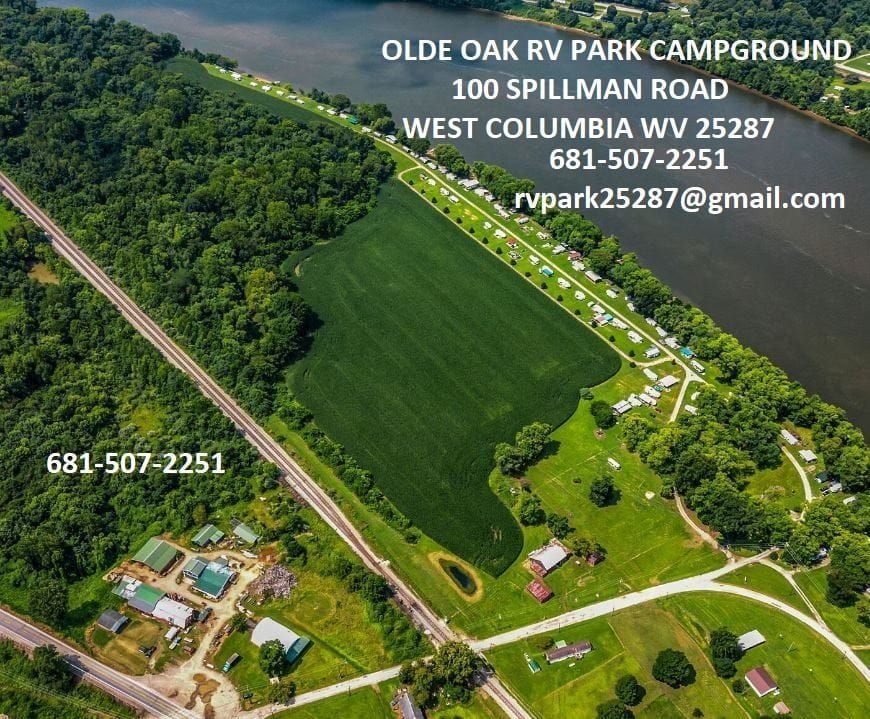 Aerial view of Olde Oak RV Park campground with green fields, roads, and contact information overlay.