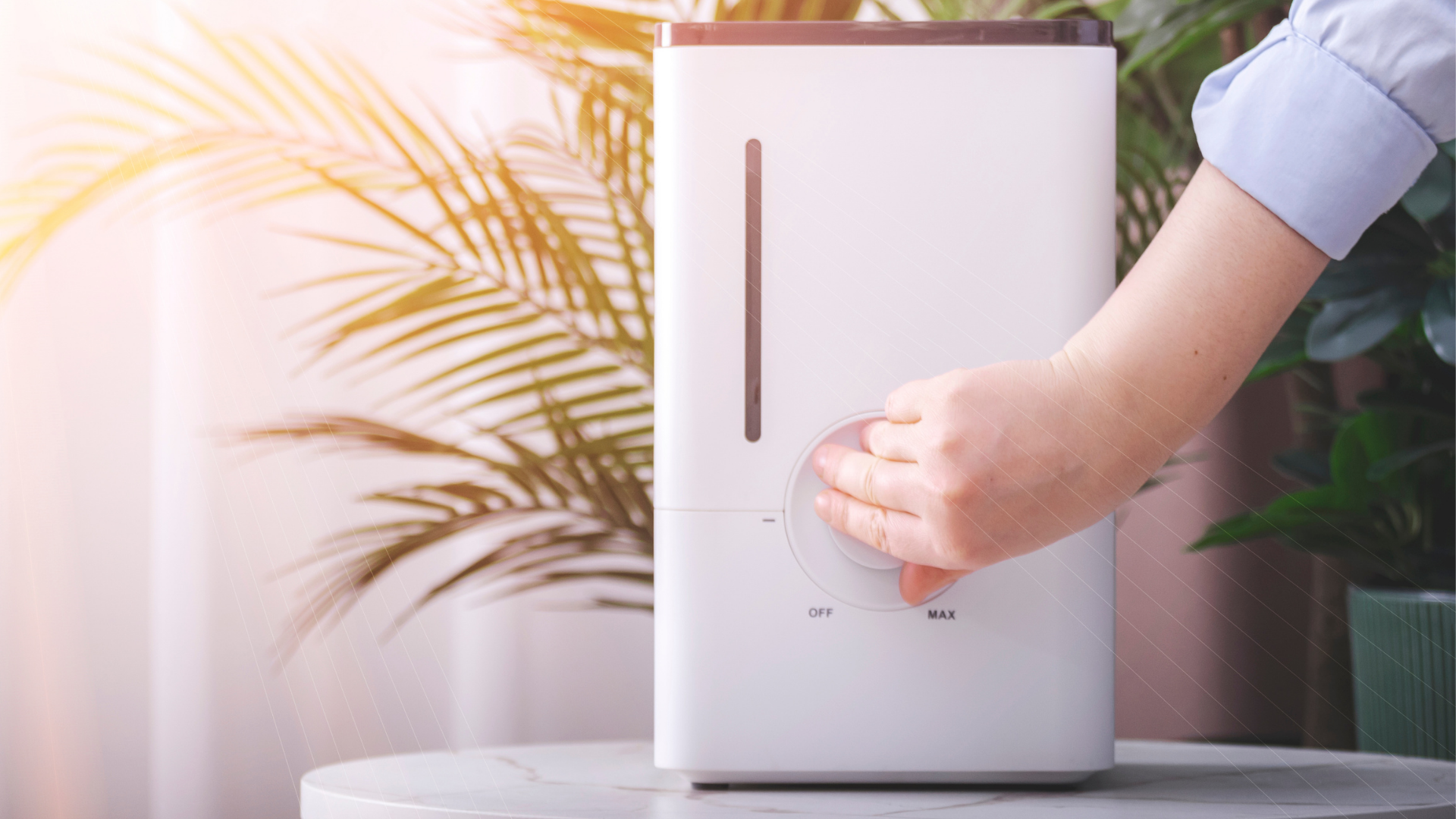 Hands holding a square ceiling vent cover being installed on a white wall
