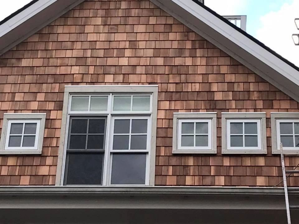 A house with wooden shingles and a lot of windows