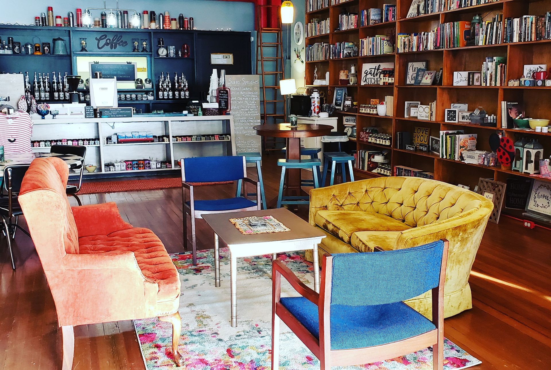 A living room with a yellow couch and blue chairs