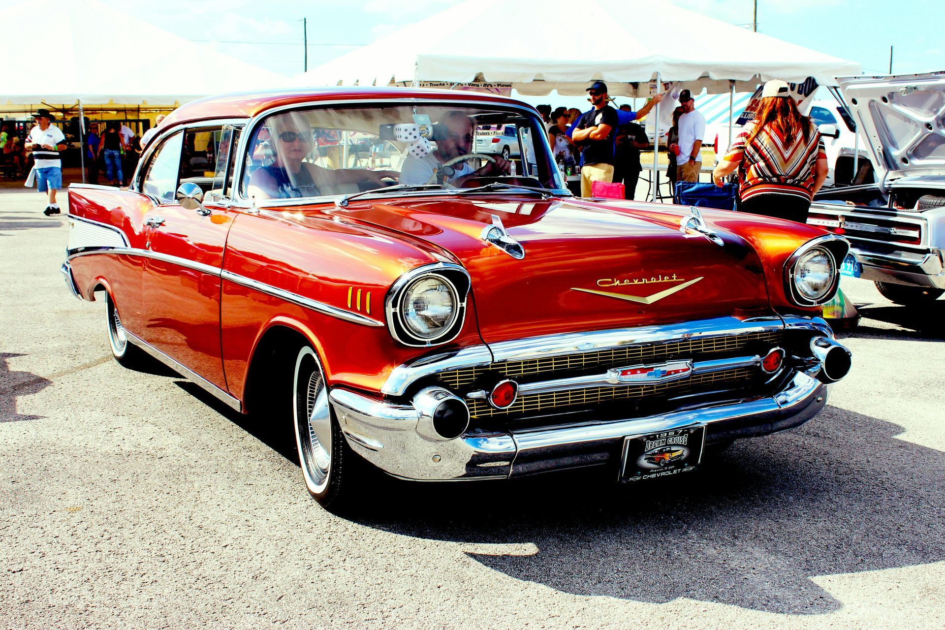 A red chevrolet is parked in a parking lot