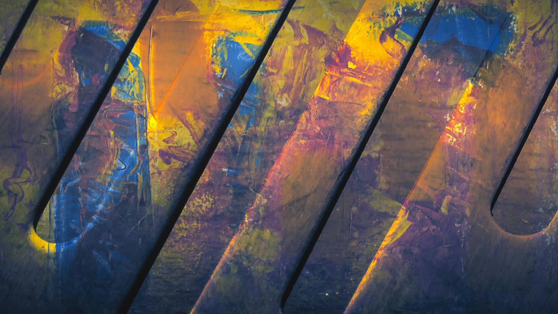 Diagonal grooves with splattered paint in shades of blue, yellow, and pink.