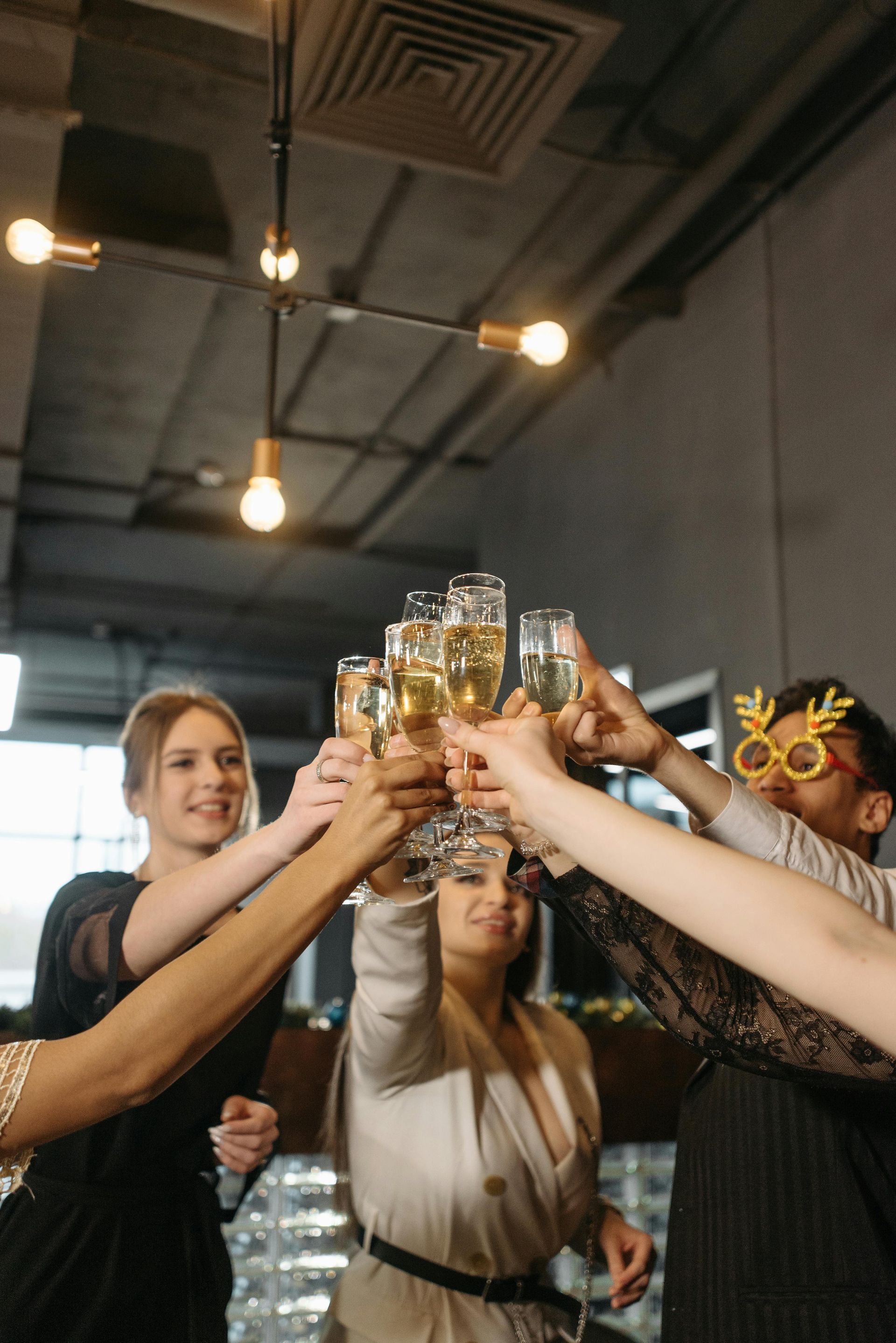 A group of people are toasting with champagne glasses at a party.