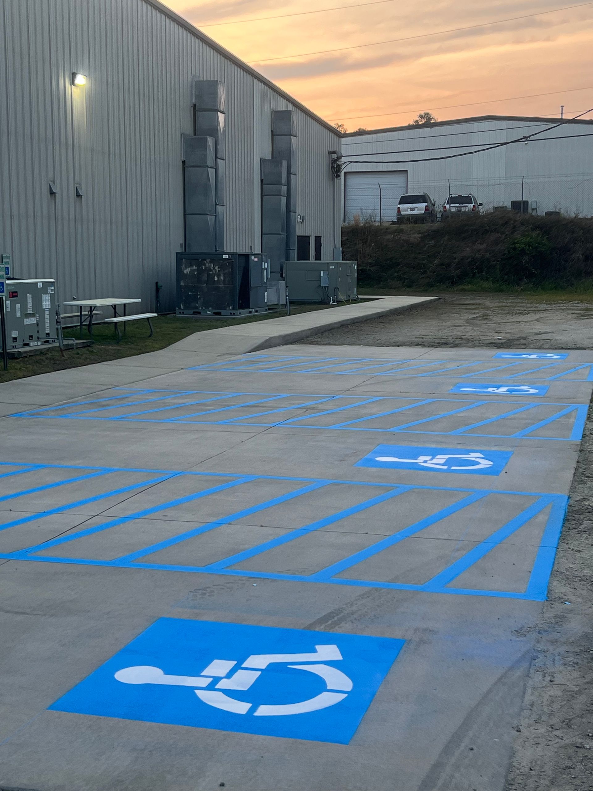 A parking lot with a handicap sign painted on it