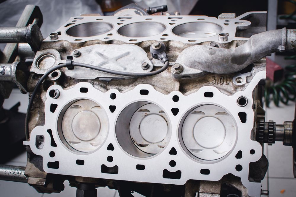 Engine Block With Exposed Pistons and Gasket, in a Workshop Setting — Enterprise Auto Repairs in Kunda Park, QLD