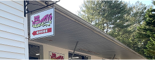 A sign on the side of a building says `` office ''. | Ed's Automotive