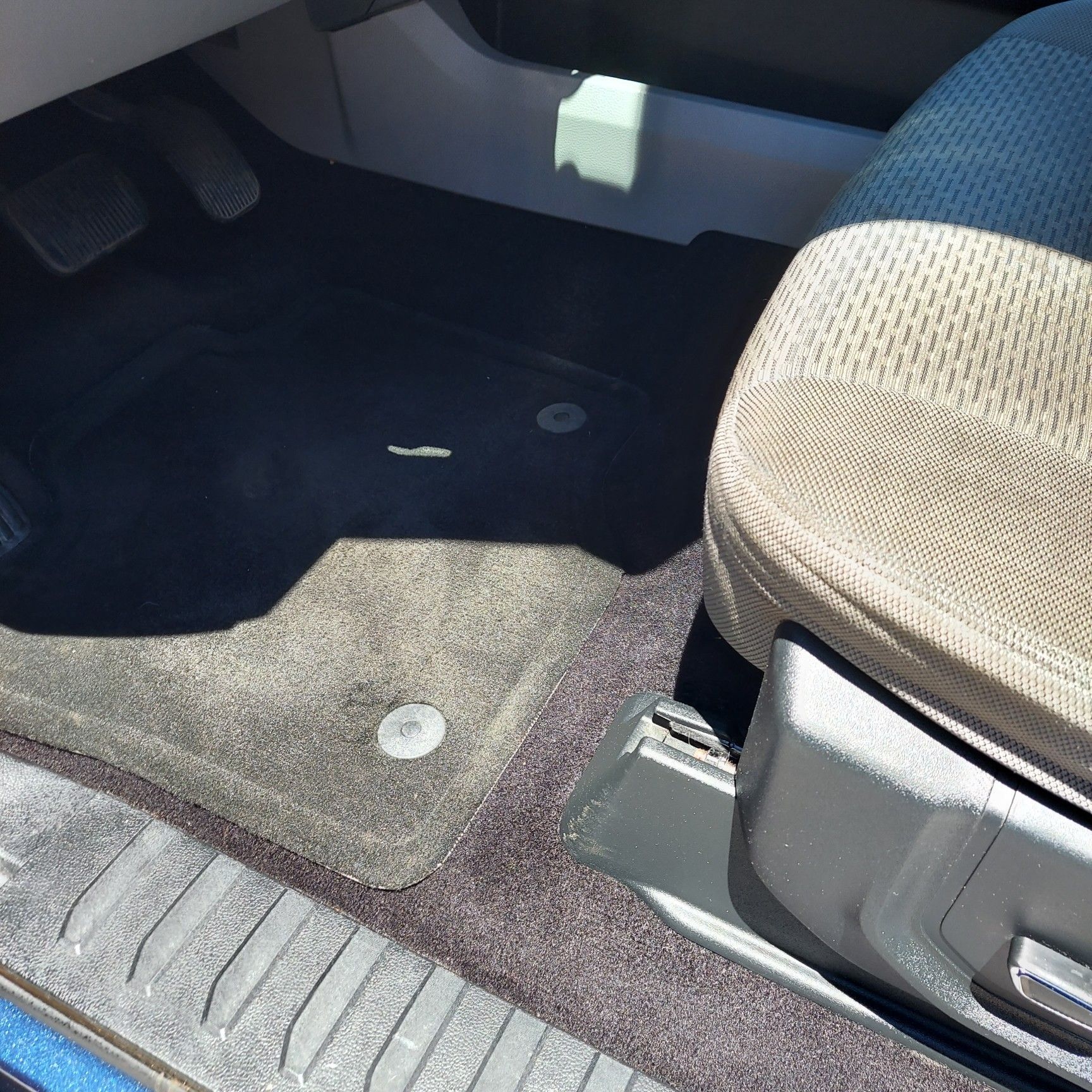 The inside of a car with a seat and floor mats | Ed's Automotive