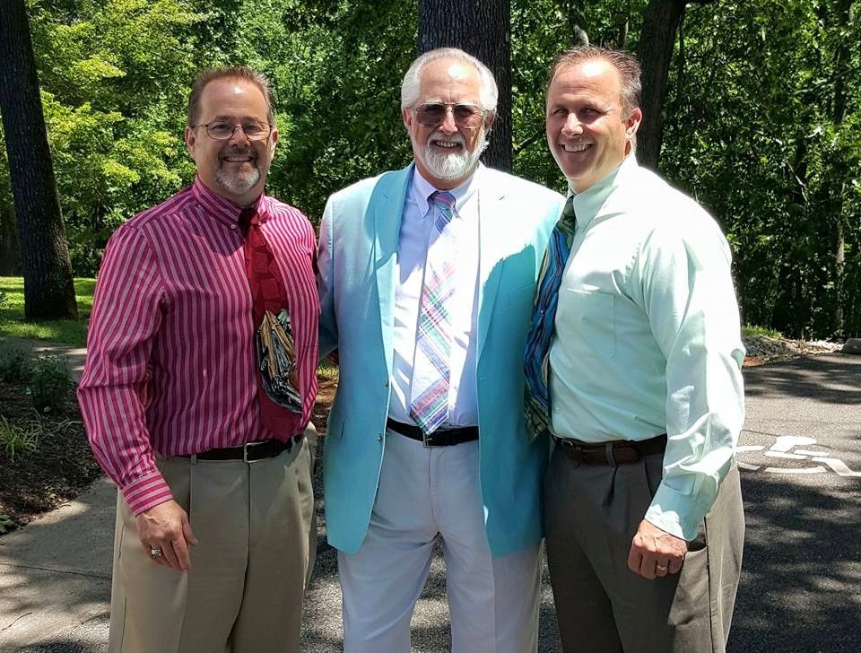 A man with a beard wearing sunglasses and a striped shirt | Ed's Automotive