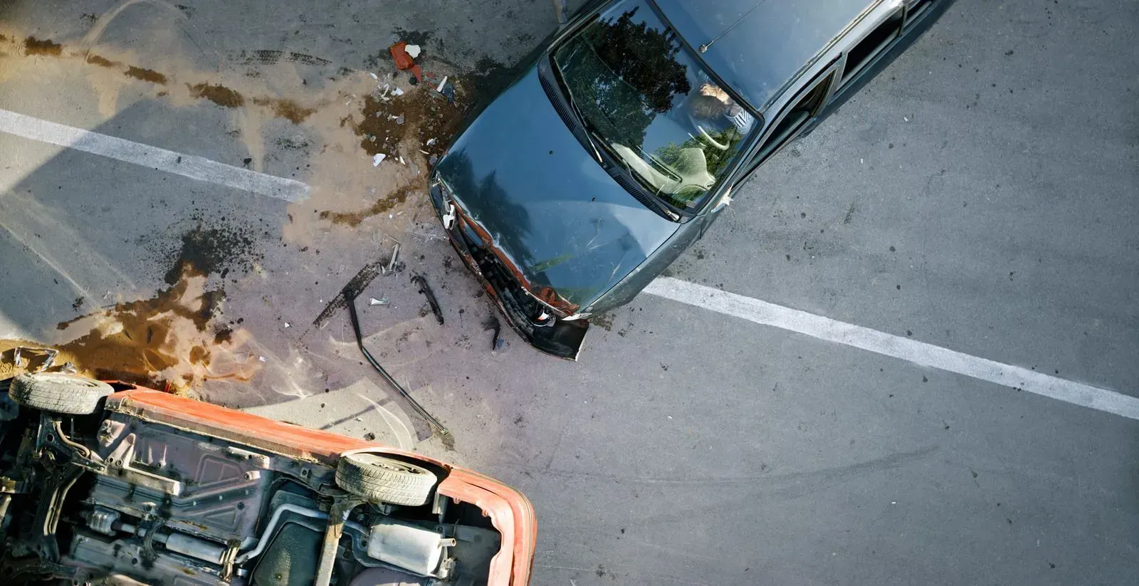 An aerial view of two cars that have crashed into each other.