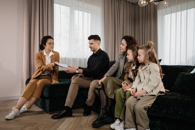 a landlord doing a home visit with a family in a rental property