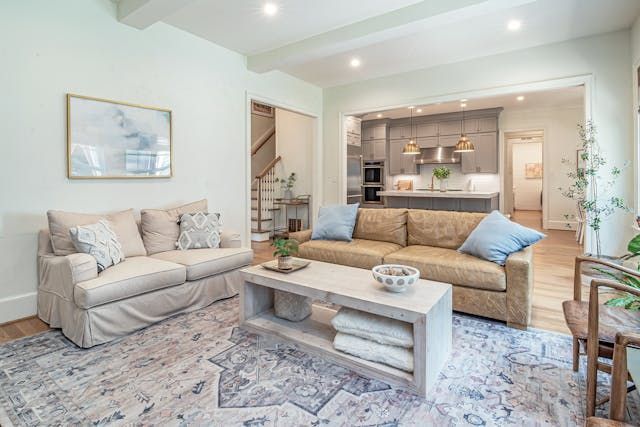 a living room and kitchen with a light color pallet