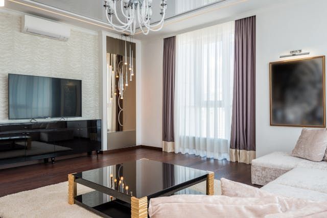 a living room and kitchen with a light color pallet