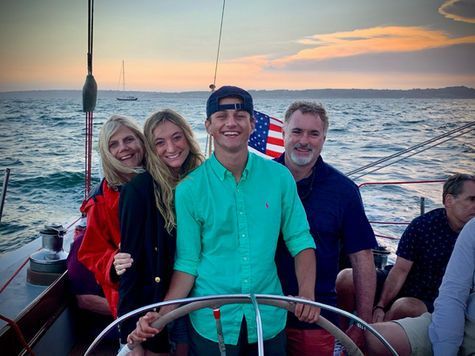 A group of people are sitting on a boat in the ocean.