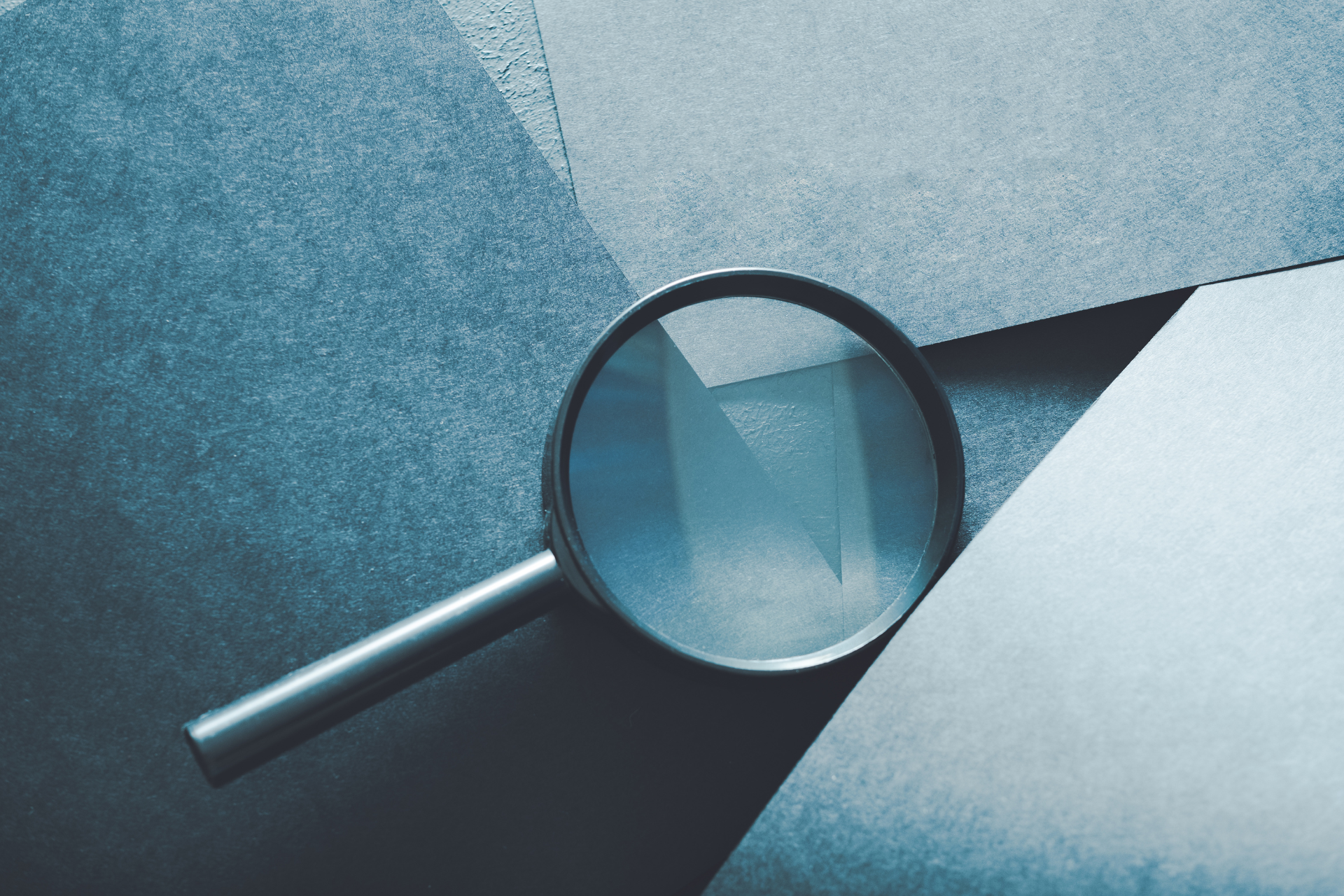 A magnifying glass is sitting on top of a piece of paper.