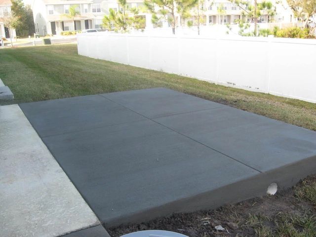 Concrete Driveway With A White Fence | Tampa, FL | Mr. Patio