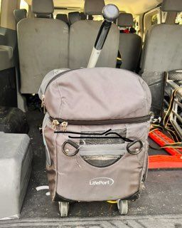 A lifeport bag is sitting in the back of a van
