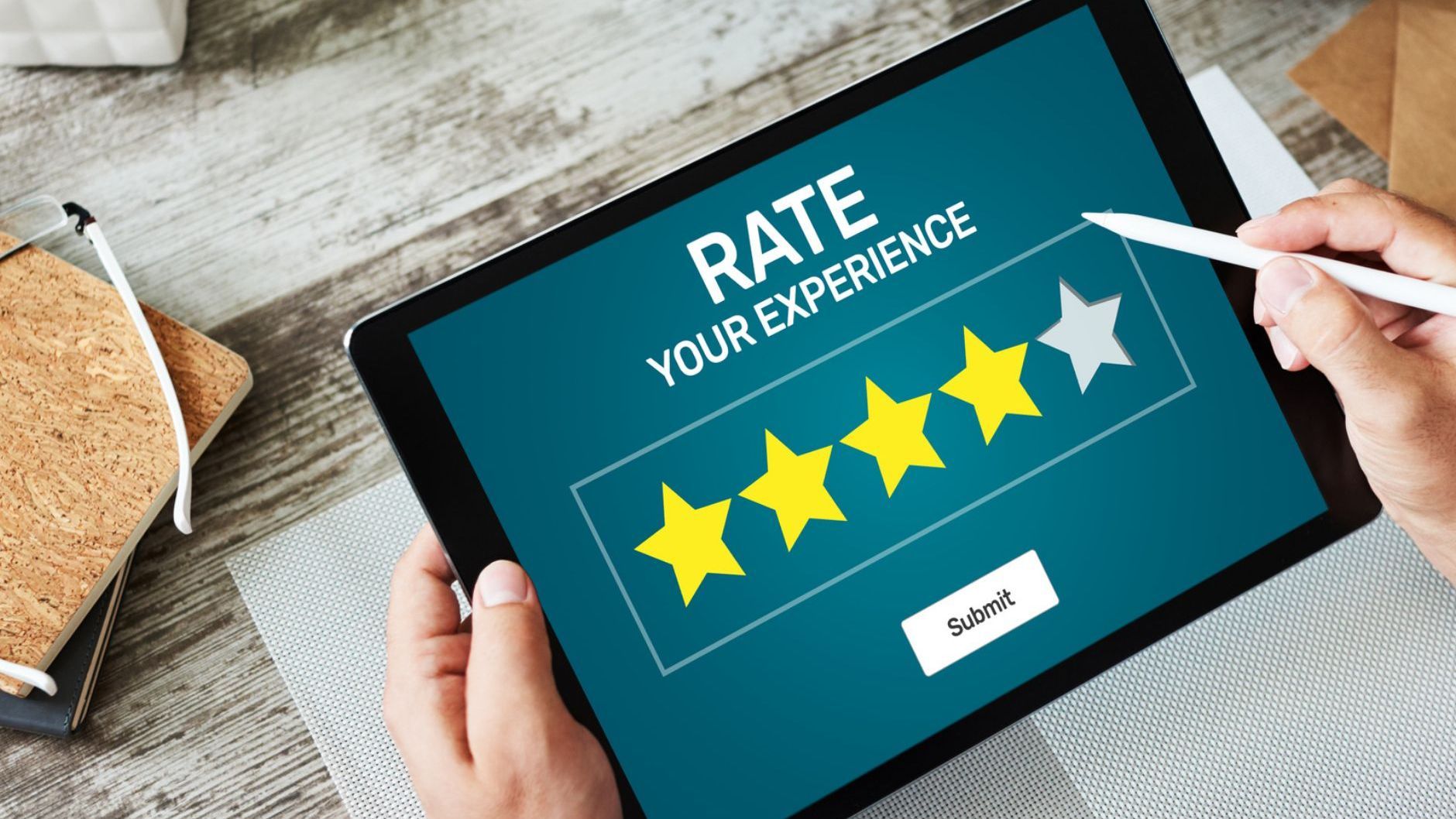 A person is holding a tablet that says `` rate your experience ''.