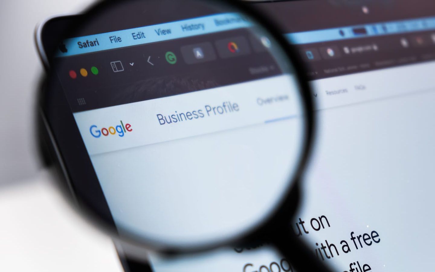 A magnifying glass is looking at a google business profile