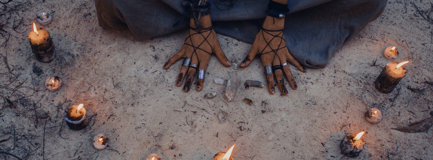 vrouwenhanden in een cirkel van brandende kaarsen