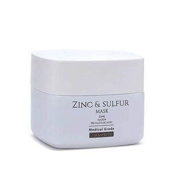 White jar of Zinc & Sulfur mask with gray label on a plain background