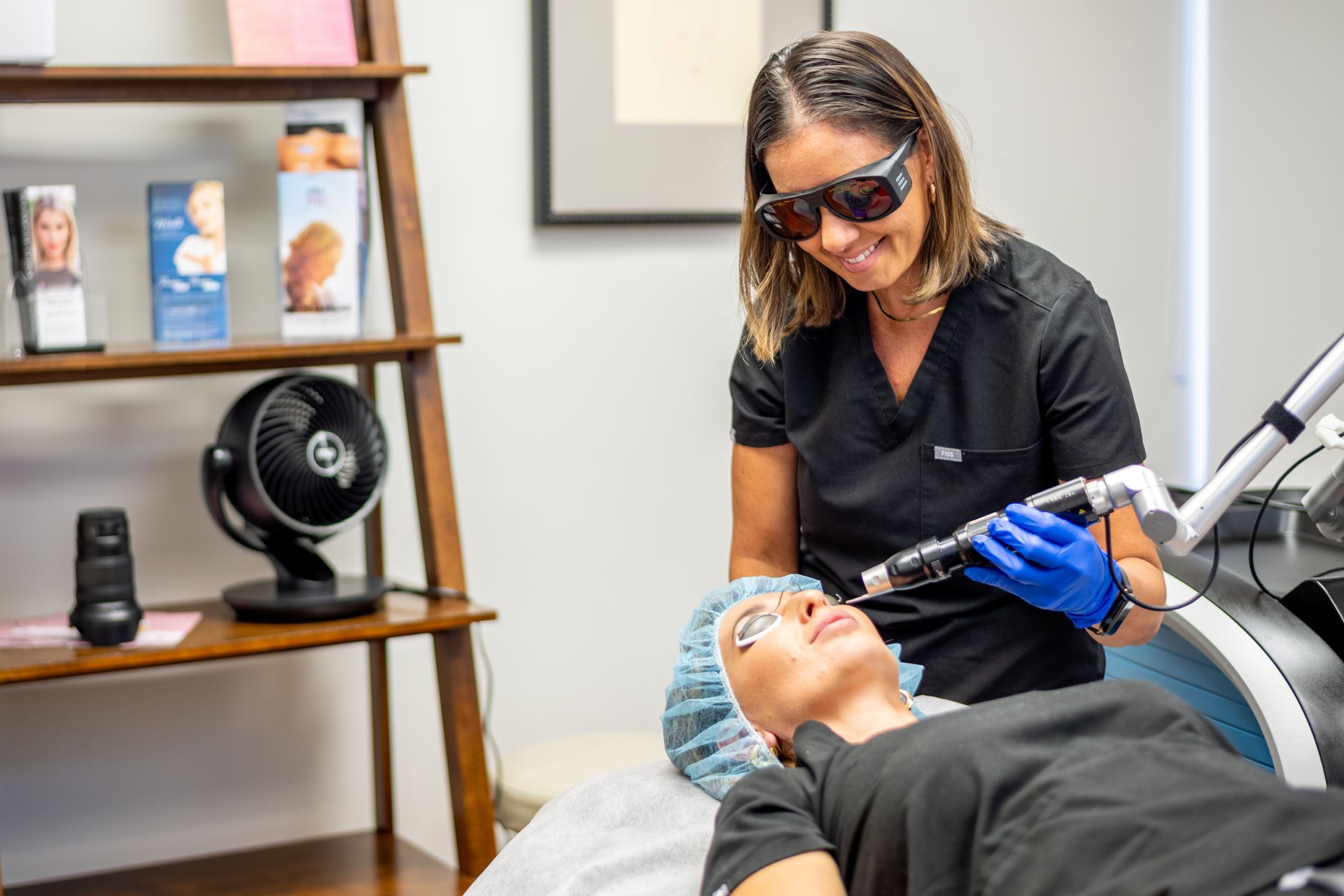 a woman is getting a laser treatment on her face .
