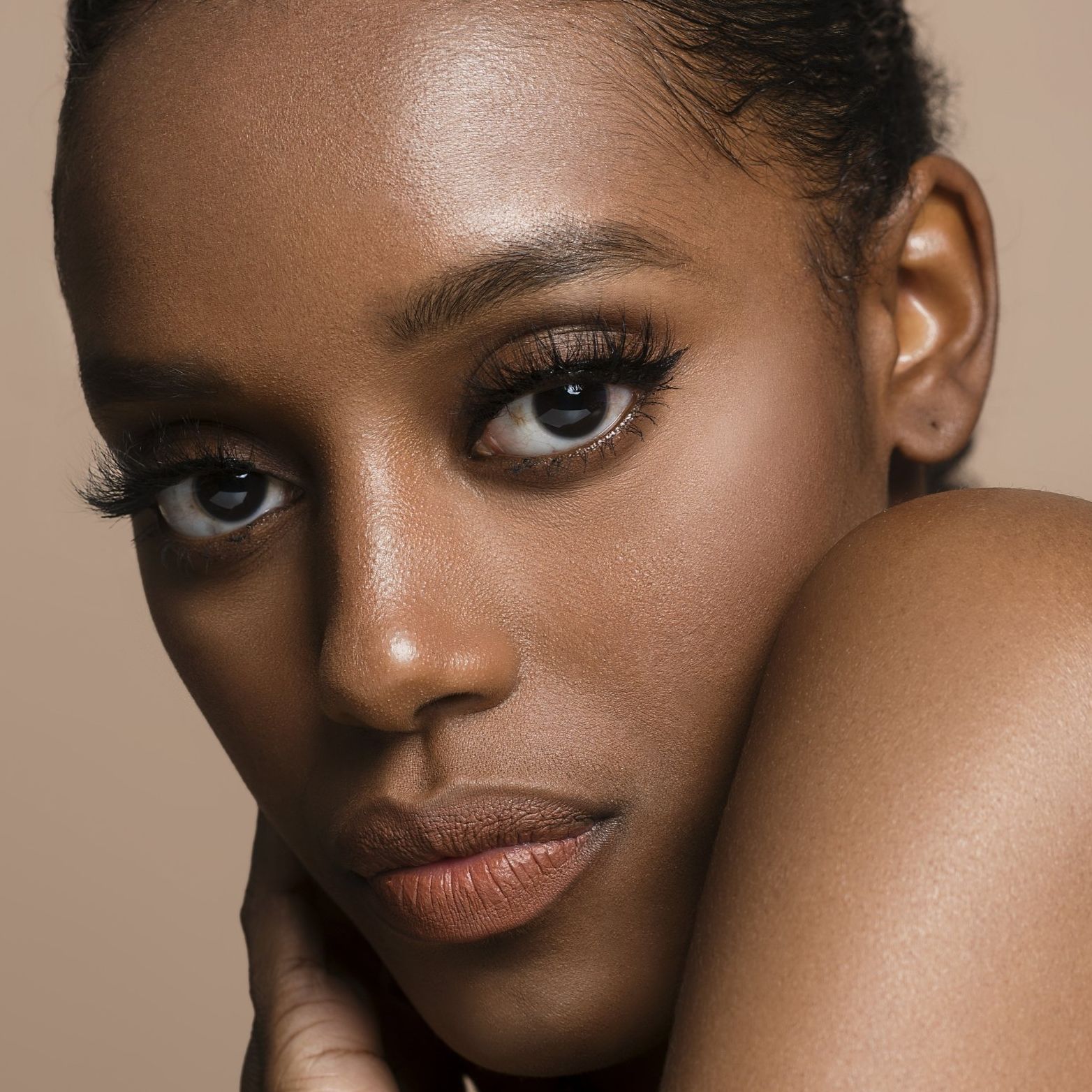 Black woman looking happy and surprised smiling at the camera