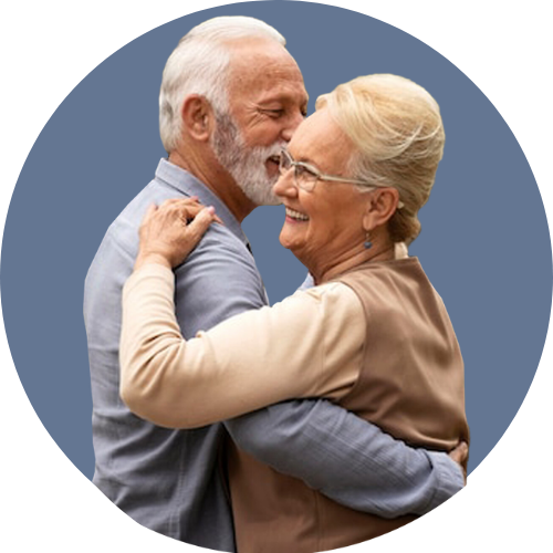 A man and a woman are hugging each other and smiling.