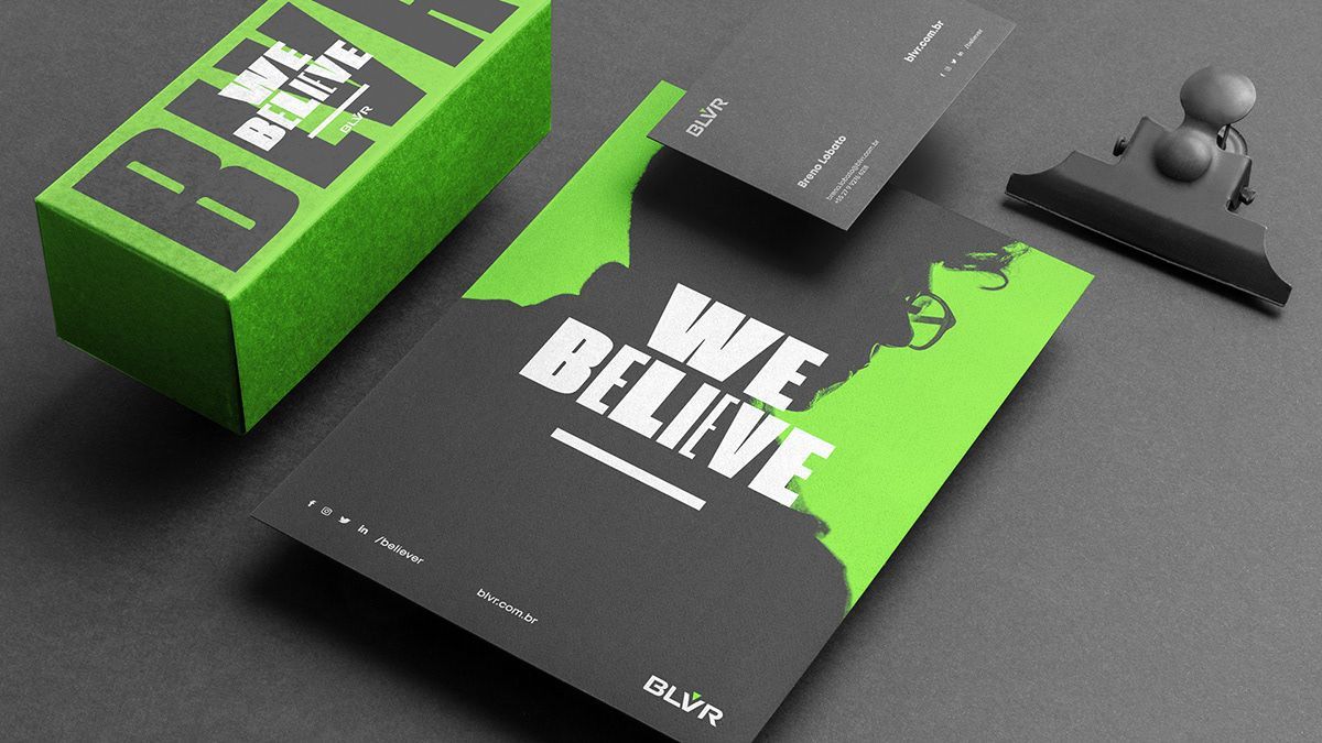 A green and black business card that says we believe