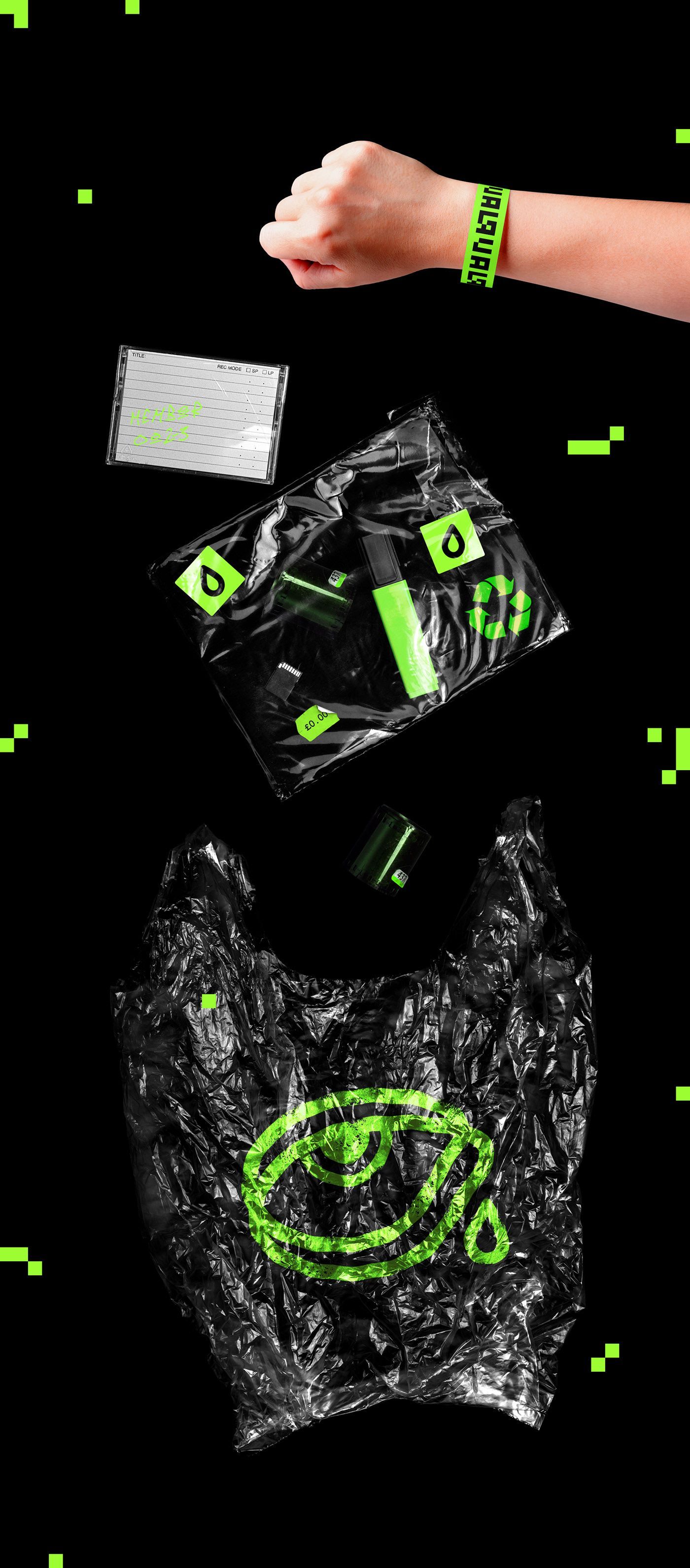 A person is throwing plastic bags into a trash can.