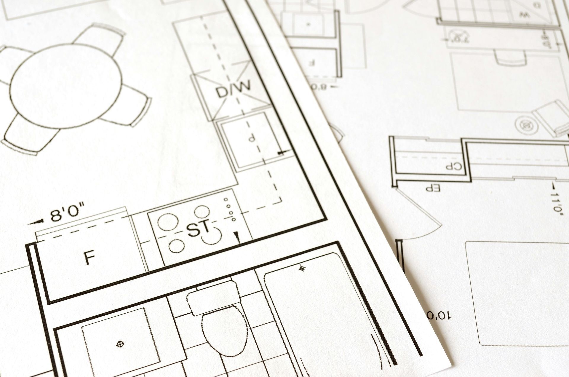 Architectural blueprints showing a kitchen and dining area layout. 