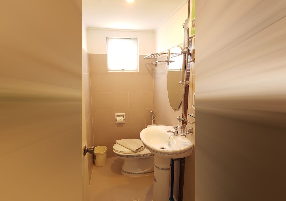 A bathroom with a sink , toilet and mirror