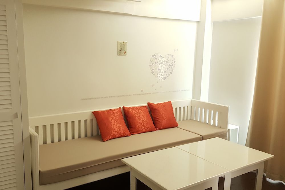 There is a couch and a table in the room.