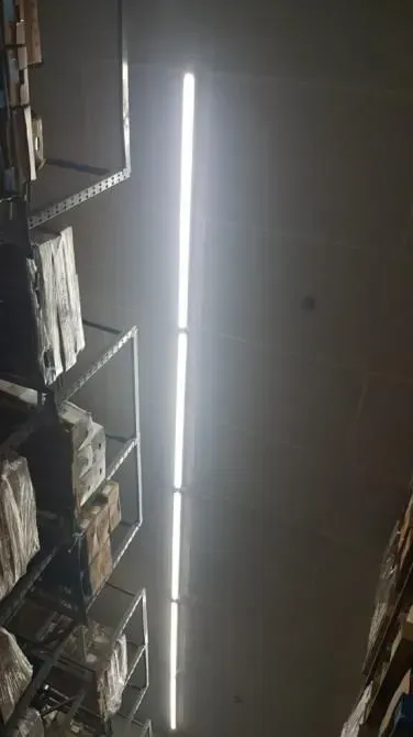 Fluorescent ceiling lighting in commercial store aisle