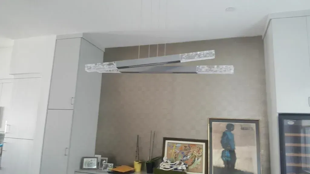 Hanging light fixture and recessed wall alcove in residential living room