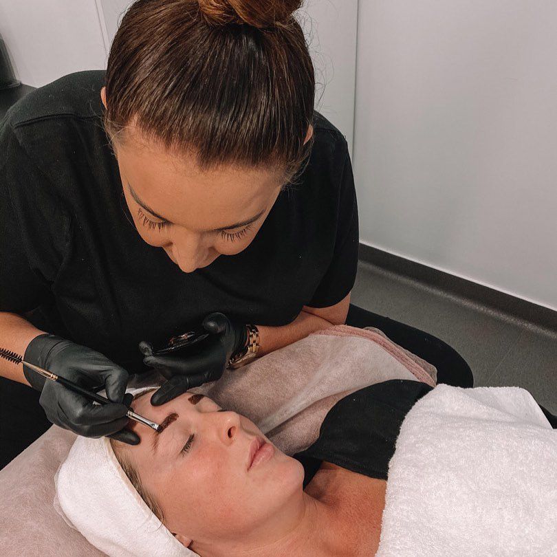 A Woman Is Laying On A Bed Getting Her Eyebrows Done — Beauty & Laser by Sarah in Long Jetty, NSW