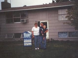 Family standing in front of a house with a 