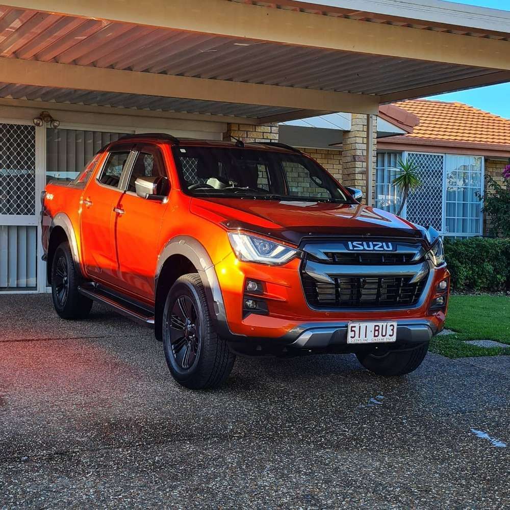 An Isuzu Truck is Parked Under a Canopy in Front of a House — Remedy Mobile Car Detailing in Gold Coast, QLD