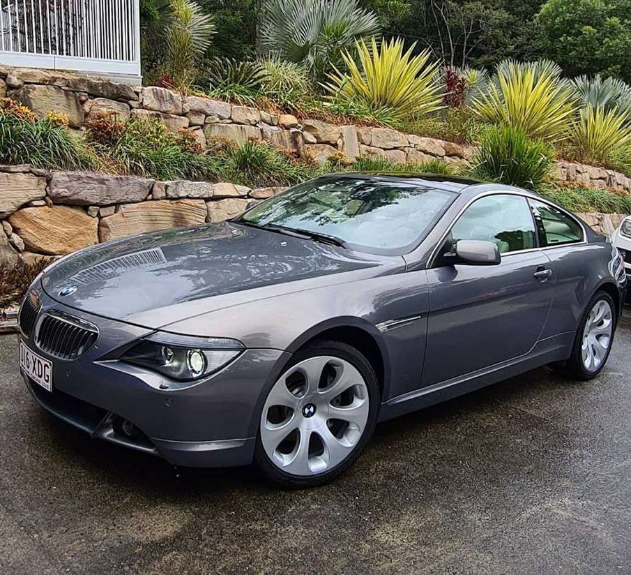 A Gray Bmw Is Parked In Front Of A Stone Wall — Remedy Mobile Car Detailing in Gold Coast, QLD