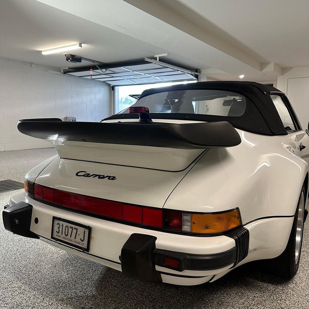 A White Porsche Carrera Turbo Is Parked In A Garage — Remedy Mobile Car Detailing in Burleigh, QLD