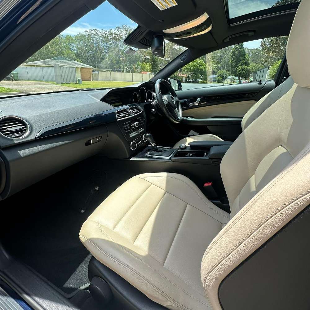 The Interior Of A Car With White Leather Seats And A Sunroof — Remedy Mobile Car Detailing in Gold Coast, QLD